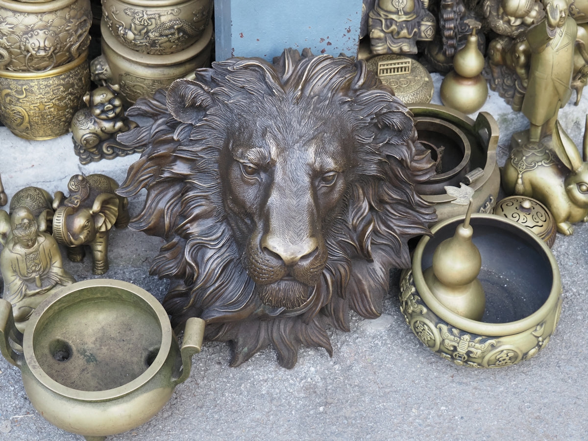 a statue of a lion surrounded by other items